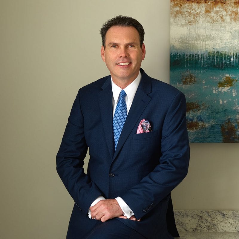 Terrence Liff wearing suit in front of painted artwork