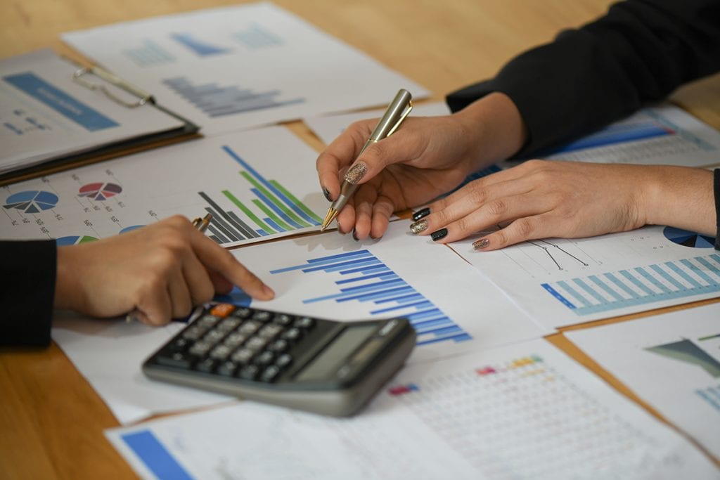 Accounting staff reviewing charts and graphs