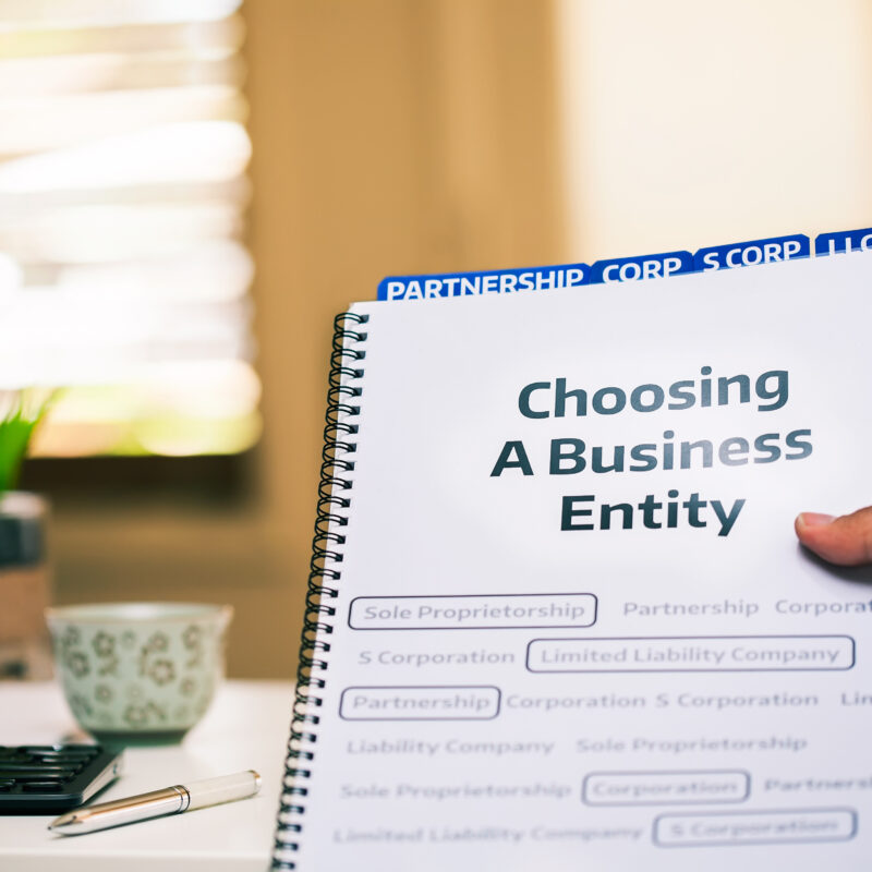 liff walsh simmons business entity formation llc A document on different types of business formations being read by a small business owner while sitting in office desk.